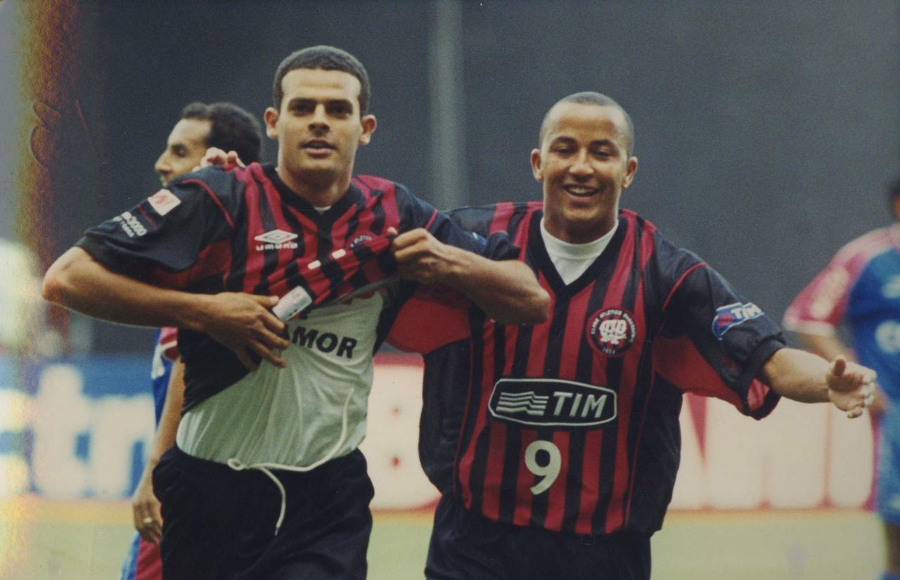 Ilan comemora com Alex Mineiro o primeiro gol do triunfo em 2001.
